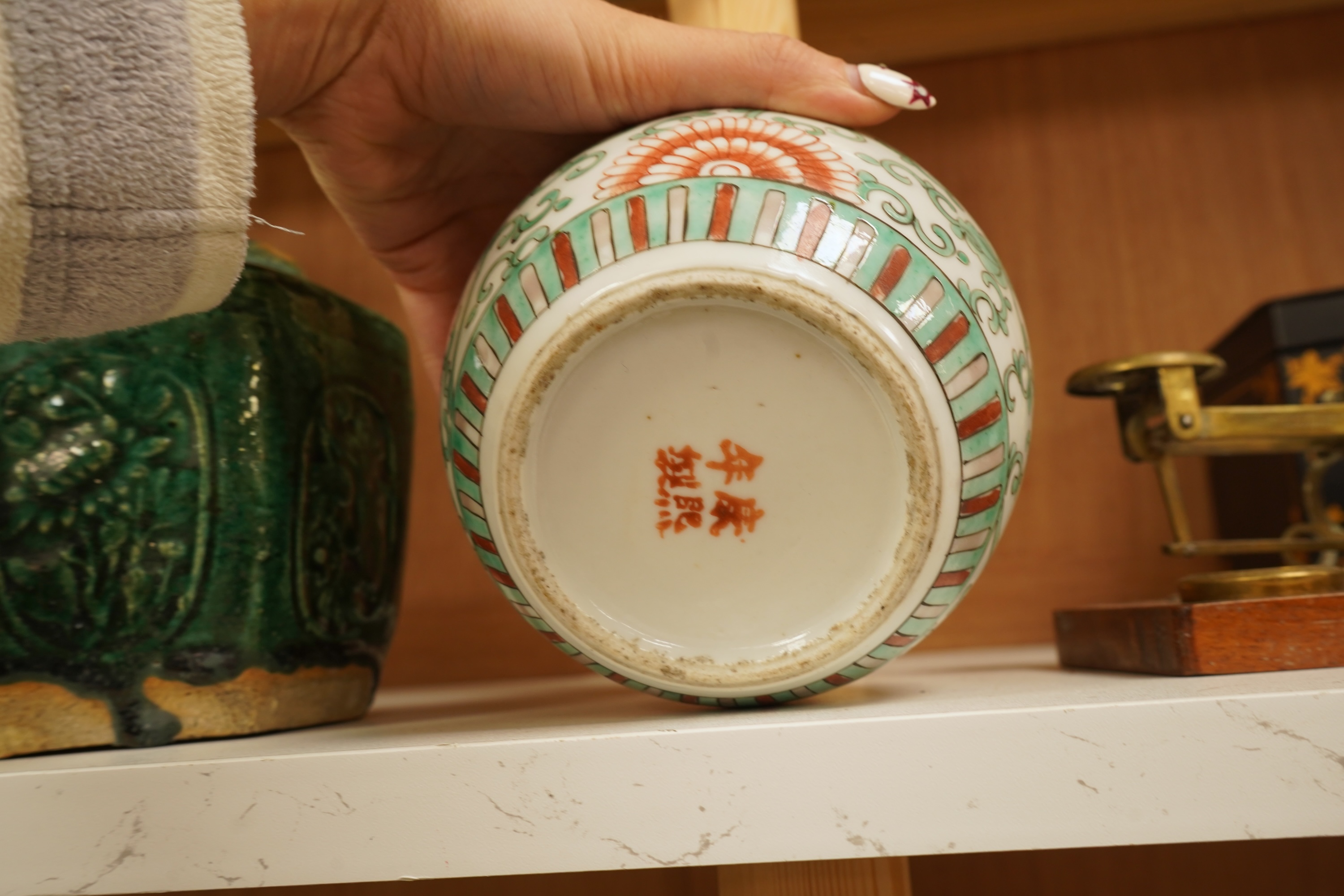 A Chinese famille verte jar and cover and a similar green glazed earthenware jar, tallest 13cm